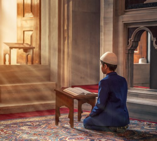 photo-of-a-person-kneeling-in-front-of-book-2608353